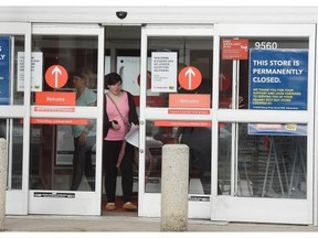 Taylor Paquette walks out of the west end Future Shop store after being laid off in Edmonton on Saturday Mar. 28, 2015.