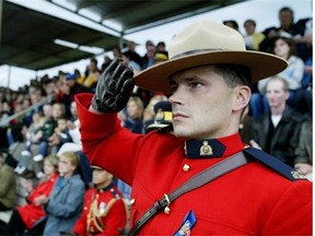 Then constable Lee Johnston, twin brother of slain RCMP officer Leo Johnston, salutes the RCMP Musical Ride, holding a special performance in Mayerthorpe on Aug. 30, 2005, as a tribute to the four slain Mounties.