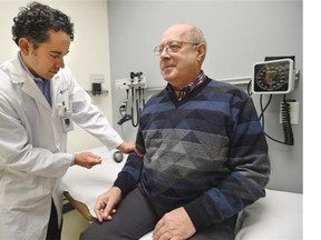 Dr. Thomas Jeerakathil, stroke neurologist checks the reflexes of stroke patient Richard Grynoch at the Kaye Edmonton Clinic in Edmonton, March 9, 2015.