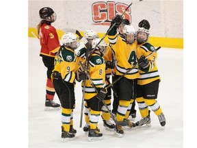 The University of Alberta Pandas celebrate a first period goal against the Calgary Dinos during Friday’s first game in a best-of-three Canada West women’s hockey semifinal series at Clare Drake Arena.