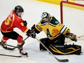 University of Alberta Pandas goalie Lindsey Post makes a save against Jenna Smith of the Calgary Dinos during the opening game of a best-of-three Canada West women’s hockey semifinal series at Clare Drake Arena on Friday.