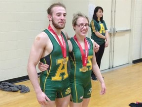 Mike Asselstine and Hayley Thomas show off gold medals at the CIS wrestling championships at the University of Alberta Main Gym on Saturday, Feb. 28, 2015.