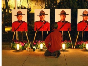In the weeks after the fatal shooting of four Mounties near Mayerthorpe, Alta., on March 3, 2005, people from across the country mourned. In Edmonton, a memorial service was held at the University of Alberta Butterdome for thousands of people. Here, university-area resident Chad Havard stops outside the Butterdome where a candlelit memorial was set up for the four officers, from left, Peter Schiemann, Lionid Johnston, Brock Myrol and Anthony Gordon.