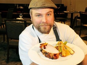 Westin Hotel executive chef Ryan O’Flynn holds a plate with a Easter roast of Canadian bacon studded with rosemary and star asnise studded Canadian bacon, with maple roasted parsnips.