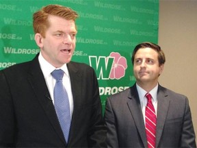 New Wildrose Leader Brian Jean holds his first news conference in Edmonton on Thursday flanked by outgoing Wildrose MLA Shayne Saskiw.