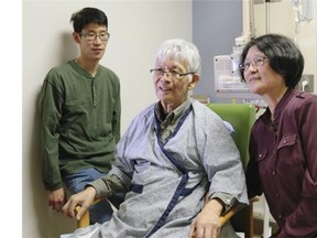 Wilfred Siu, 70, received a new liver that had been connected to a portable device which kept the donor organ warm outside the body, with blood circulating through it. Siu is with his wife Anita and son Merwin. University Hospital was the first transplant team in North America to use the device.