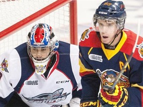 Windsor Spitfires goalie Alex Fotinos, left, patrols the net as Erie Otters centre Connor McDavid waits for the puck during OHL action Sept. 26, 2014 at the WFCU Centre in Windsor, Ont.