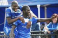 Lance Laing celebrates his fourth goal of the season with FC Edmonton teammate Kareem Moses during the second half of Sunday’s North American Soccer League game Aug. 24, 2014, against the Fort Lauderdale Strikers at Clarke Field.