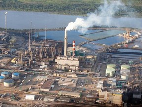 An aerial view Suncor’s base plant oilsands upgrading facility next to their oilsands mining operations north of Fort McMurray, Alta. on June 18, 2013.  The plant converts bitumen which is extracted from oilsands into synthetic crude oil which is then piped to southern refineries.