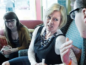 Alberta NDP Leader Rachel Notley speaking with young supporters after making an announcement about the Summer Temporary Employment Program, at Remedy Cafe in Edmonton, April 21, 2015.