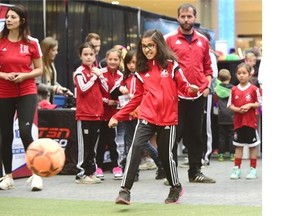Amana Sharma, 8, kicks the ball at the robot goalie interactive game at the Women’s World Cup Trophy Tour at West Edmonton Mall in Edmonton on May 16, 2015.
