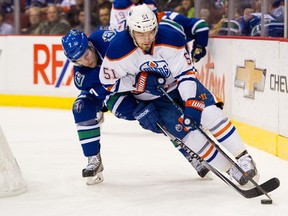 Anton Lander plays a 200-foot game, from one ed wall to the other. Here he escapes the forechecking of Vancouver's Linden Vey.