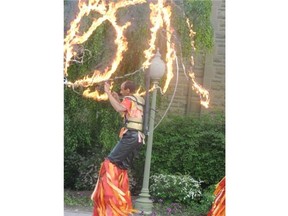 Artist and stilt walker Randall Fraser performs as a flaming dragon. The Thousand Faces festival has had to cancel this weekend’s performance because of the Edmonton fire ban.