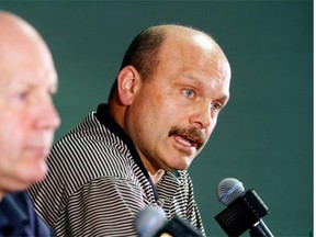 Boston Bruins general manager Peter Chiarelli, right, speaks alongside head coach Claude Julien at a news conference at TD Garden in Boston on April 13, 2015 after the Bruins failed to reach the playoffs for the first time in eight years.