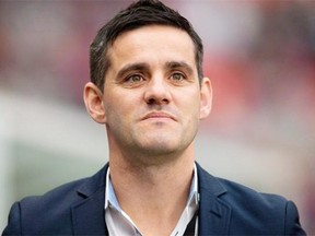 Canada’s national women’s soccer team head coach John Herdman watches his players warm up before an international friendly soccer game against Mexico in Vancouver, B.C., on Sunday November 24, 2013.