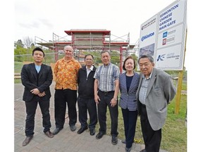 Chinese Garden Society supporters, from left, Sunny Sun, Ken Friedrich, Francis Ng, Wing Choy, Mary Fung and Dr. Steven Aung in front of the new gate going up in the Chinese Garden in Louise McKinney Riverside Park.