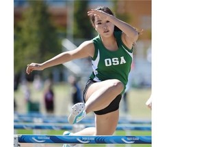 Clara Zhou of Old Scona High School takes part in the hurdles event during the Edmonton high school track and field championships at Foote Field on Wednesday.