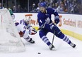 Toronto Maple Leafs' Cody Franson skates past New York Rangers' Ryan Callahan, left, during first period NHL hockey action in Toronto, Saturday January 4, 2014.