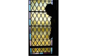 Darrel Babuk stands in front of a stained glass window in downtown Edmonton’s First Presbyterian Church. The window is being removed and sent to Vancouver for cleaning.
