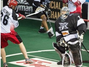 Daryl Veltman of the Calgary Roughnecks hits the crossbar against Edmonton Rush netminder Aaron Bold during Friday’s National Lacrosse League playoff game against the Edmonton Rush at Rexall Place.