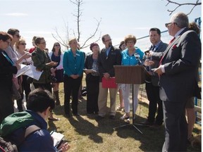 Edmonton Catholic school board chairwoman Debbie Engel, (in blue blouse) is joined by other educators Monday in Edmonton to speak out against provincial cuts to education.