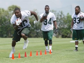 Edmonton Eskimos running back Shakir Bell (30), left, runs through footwork drills with teammates Jeremy Hold (34) and Jamal Berry (33) during the mini-camp at Historic Dodgertown in Vero Beach, Fla., on April 19, 2015.