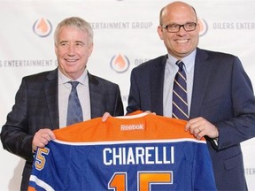 Edmonton Oilers CEO Bob Nicholson, left, and new president of hockey operations and general manager Peter Chiarelli speak during Friday’s press conference announcing several management changes in the NHL organization.