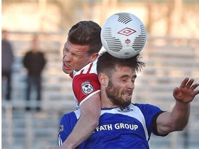 FC Edmonton’s Ritchie Jones (front) and Ottawa Fury’s Nicki Paterson go up for the header in the Amway Canadian Championship game at Clarke Stadium on Wednesday.