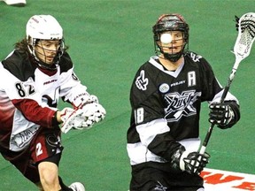 Edmonton’s Rush’s Zack Greer, right, and Colorado Mammoth’s Joey Cupido keep their eyes on the ball during a National Lacrosse League game at Rexall Place on April 18, 2015.