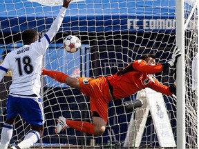 FC Edmonton striker Tomi Ameobi celebrates a goal by teammate Lance Laing (not pictured) on Minnesota United FC goalkeeper Mitch Hildebrandt in a North American Soccer League game at Clarke Field on May 3, 2015.