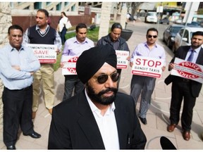 Edmonton Taxi Association president Jasbir Gill speaks to the media during a rally against bandit taxis at City Hall, in Edmonton April 28, 2015.