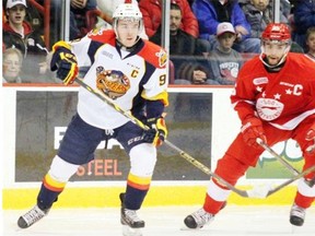 Erie Otters forward Connor McDavid, left, and Soo Greyhounds defenceman Darnell Nurse follow the puck during OHL playoff action on April 24, 2015, in Sault Ste. Marie, Ont.