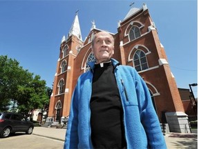 Father Jim Holland stands in front of Sacred Heart Church of the First Peoples in Edmonton on Wednesday, July 11, 2012.