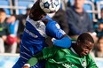 FC Edmonton's Horace James tries to head the ball past New York Cosmos Danny Mwanga at Clarke Stadium on September 28, 2014 in Edmonton.