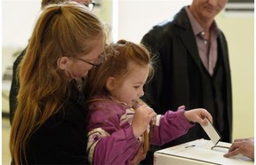 Five-year-old Jasmine Wronko helps her mom Cheri Harris vote in the advance poll at Edmonton’s McKernan Community Hall on April 29, 2015.  Graham Thomson urges readers to ignore the polls and vote for their own reasons.