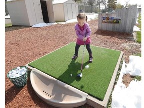 Four-year-old Juli­et James came out to hit some balls with her dad Robb James at the Vic­toria Driving Range in Edmonton on Thurs­day May 7, 2015. Robb is a teach­ing Pro at Vic­toria Golf Course.