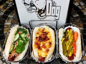 From left, the Bahn Mi Dog (beef and pork dog, head cheese, pate, mayo, cucumber slice, do chua, jalapeno, cilantros), the Trailer Trash Dog (beef and pork dog, macaroni & cheese, bacon), and the Chicago Dog (beef dog, green relish, slice tomato, sport pepper, dill pickle spear, yellow mustard)