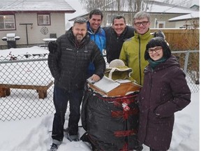 From right to left, Jocelyn Crocker and husband Mike Hamilton, Matthew Boeckner, Kevin McEwan and Chris Floden next to their beehive for an update on the backyard beekeeping pilot project in Edmonton, February 6, 2015.