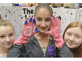 Grade 8 Westlawn School students Emily Aastrom, Mariam Choukair and Haili Koikkalainen with their “Llama-liscious Dish Gloves” with built in sponges and soap, at the Invention Convention at the Centre For Education in Edmonton on Friday Apr. 24, 2015.