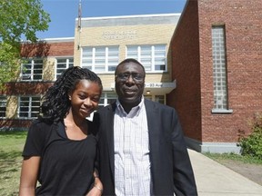 Ibrahim Karidio stands with his daughter Fatima, 14, in front of Ecole Gabrielle-Roy in Edmonton. He is one of the parents who would like to see the Francophone school board invest more into its public schools.