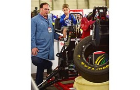 Jack Green, 7, tries his skill on a mini training excavator watched by NAIT heavy equipment instructor James Squire at the 23rd Provincial Skills Canada Competition that features high school and post-secondary students from across Alberta, competing in trade and technical events at Expo Centre in Edmonton, May 13, 2015.