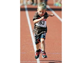 Jason Cotton sprints to the finish in the 50M race during the Edmonton Track and Field Council’s evening of family fun and sport to commemorate the grand opening of the new Rollie Miles Athletic Grounds on Friday May 22, 2015.
