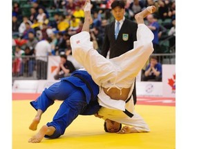 Jesus Chaparro (blue) of Mexico throws Angel Hernandez of Mexico in the under-66 kg class in the bronze medal match during the 2015 Pan-American Judo Championships at Edmonton’s Saville Community Sports Centre on April 25, 2015. Hernandez won the bout.