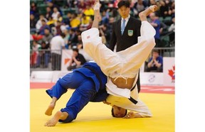 Jesus Chaparro (blue) of Mexico throws Angel Hernandez of Mexico in the under-66 kg class in the bronze medal match during the 2015 Pan-American Judo Championships at Edmonton’s Saville Community Sports Centre on April 25, 2015. Hernandez won the bout.