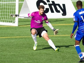 New York Cosmos goalkeeper faces FC Edmonton's Tomi Amoebi during NASL action at Edmonton's Clarke Stadium in September 2014.
