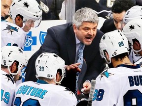 San Jose Sharks head coach Todd McLellan, centre, talks to his team during a timeout in the third period of an NHL hockey game against the Pittsburgh Penguins in Pittsburgh on March 29, 2015.