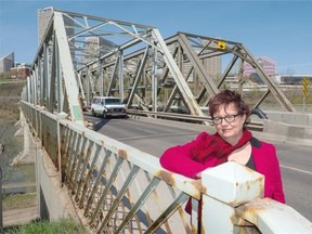 Journal columnist Paula Simons poses for a photo with Edmonton’s 115-year-old low level bridge in Edmonton on May 4, 2015.