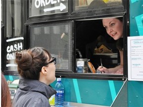 Kara Fenske, one of the owners of Drift Food Truck, takes a customer's order at their downtown location.