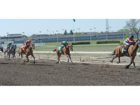 Killin Me Smalls, ridden by jockey Ruben Lara, wins the 60th annual Journal Handicap horse race at Northlands Park on Monday, May 18, 2015.