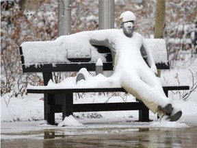 The Lunch Break sculpture in Churchill Square was plastered with snow in Edmonton on Friday March 20, 2015. Five centimetres of snow has been forecast for Wednesday.